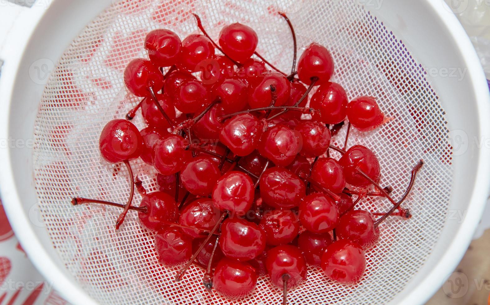 Sweet organic cherries on a sieve. Top view. photo