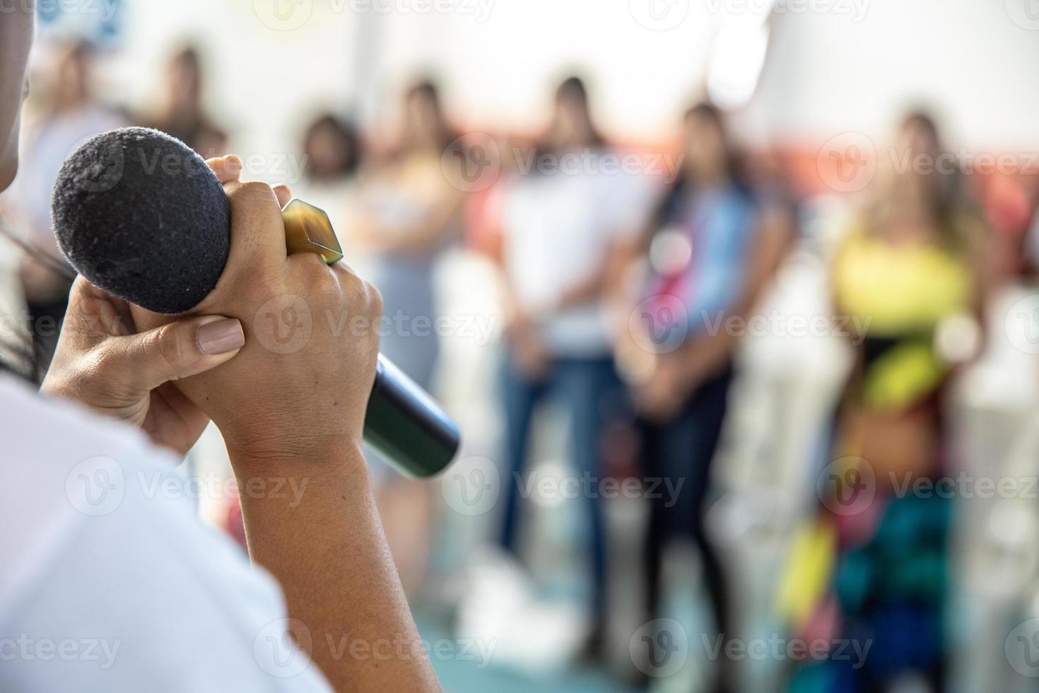 Person speaking on microphone photo