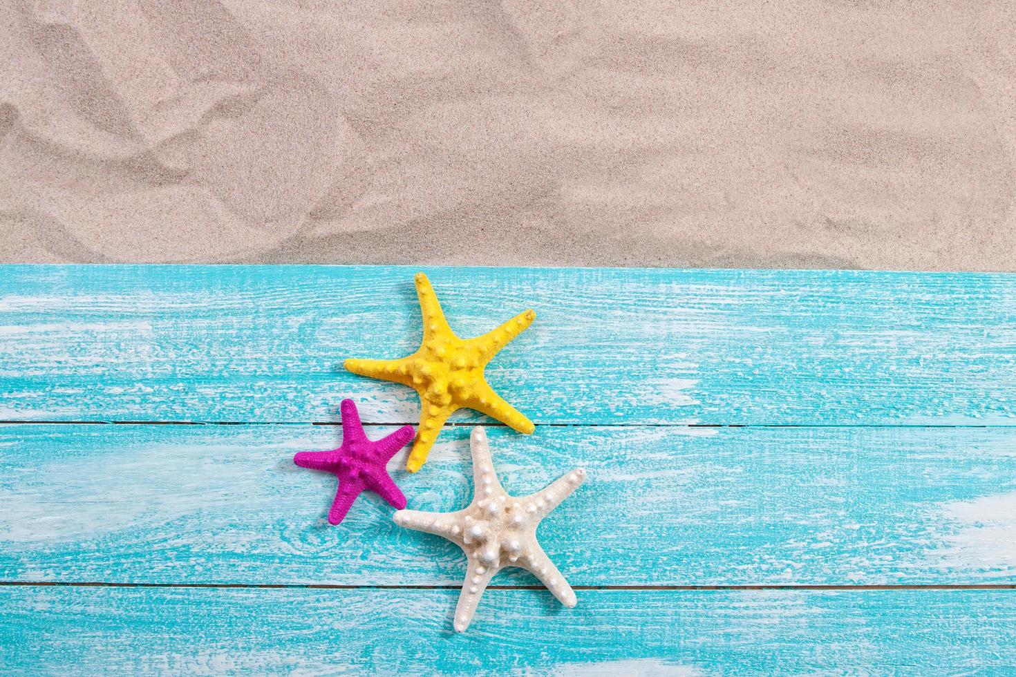 Sand copy space. Sand background top view. starfish on wooden background photo
