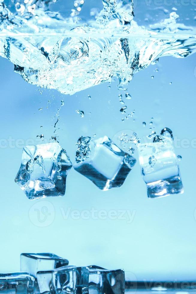 Abstract background image of ice cubes in blue water. photo