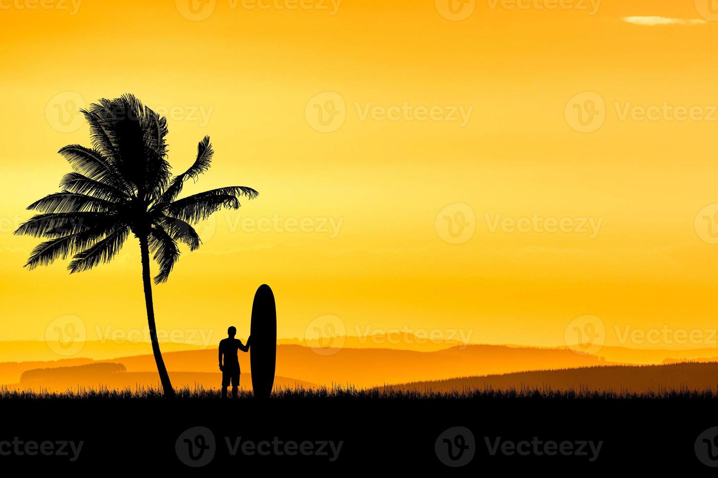 Silhouette Surfers hear at the beach with coconut palms in the morning. photo