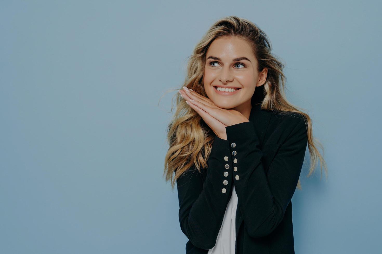 Delightful young european woman feeling happy of hearing compliment photo