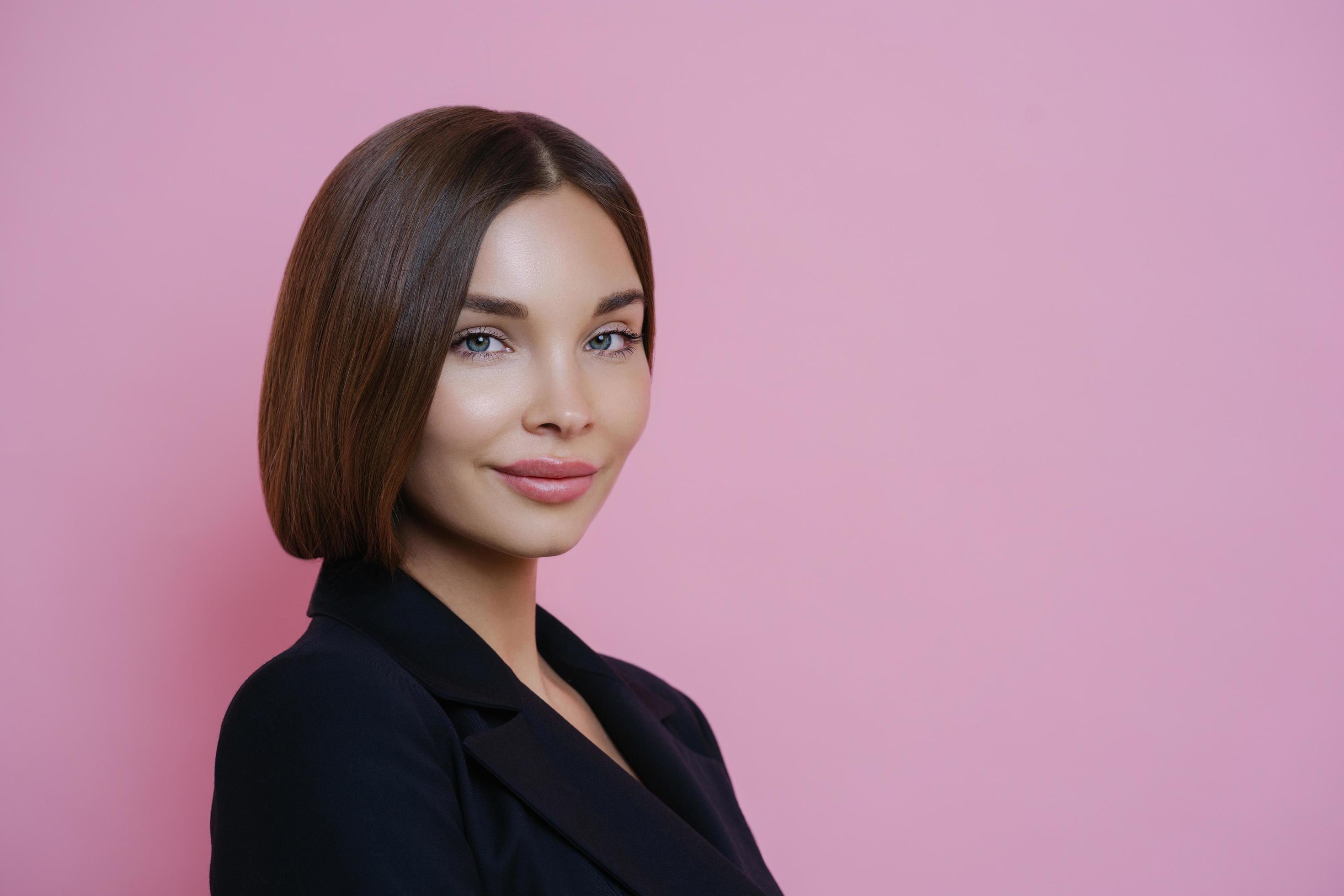 Profile shot of dark haired woman dressed in black suit, has natural makeup, looks self assured indoor, poses against pink background, empty space for your promotion. Women and elegance concept 7662572 Stock Profile shot of dark haired woman dressed in black suit, has natural makeup, looks self assured indoor, poses against pink background, empty space for your promotion. Women and elegance concept 7662572 Stock