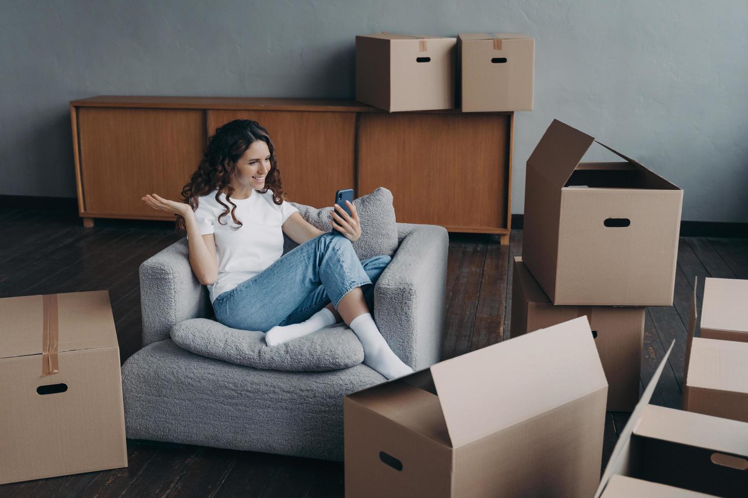 Happy girl having video call on phone showing her dream house. Mortgage loan concept. photo