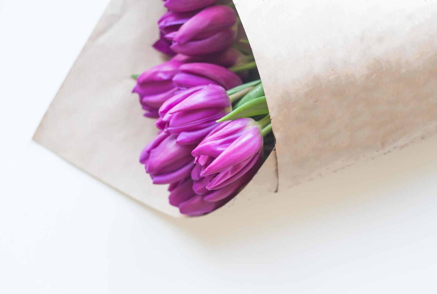 close up picture of fresh pink and purple tulips on table photo