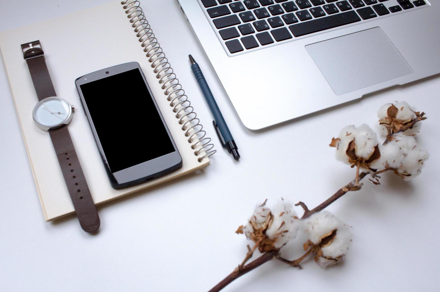 notebook on white table with gadgets and decorations, top view of writer, freelancer or buisinessman work place photo