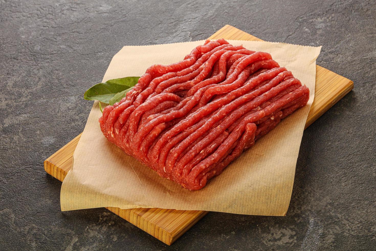 Raw beef minced meat over board photo