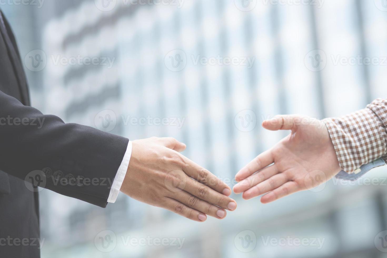 Men are holding hands to show the business vision photo