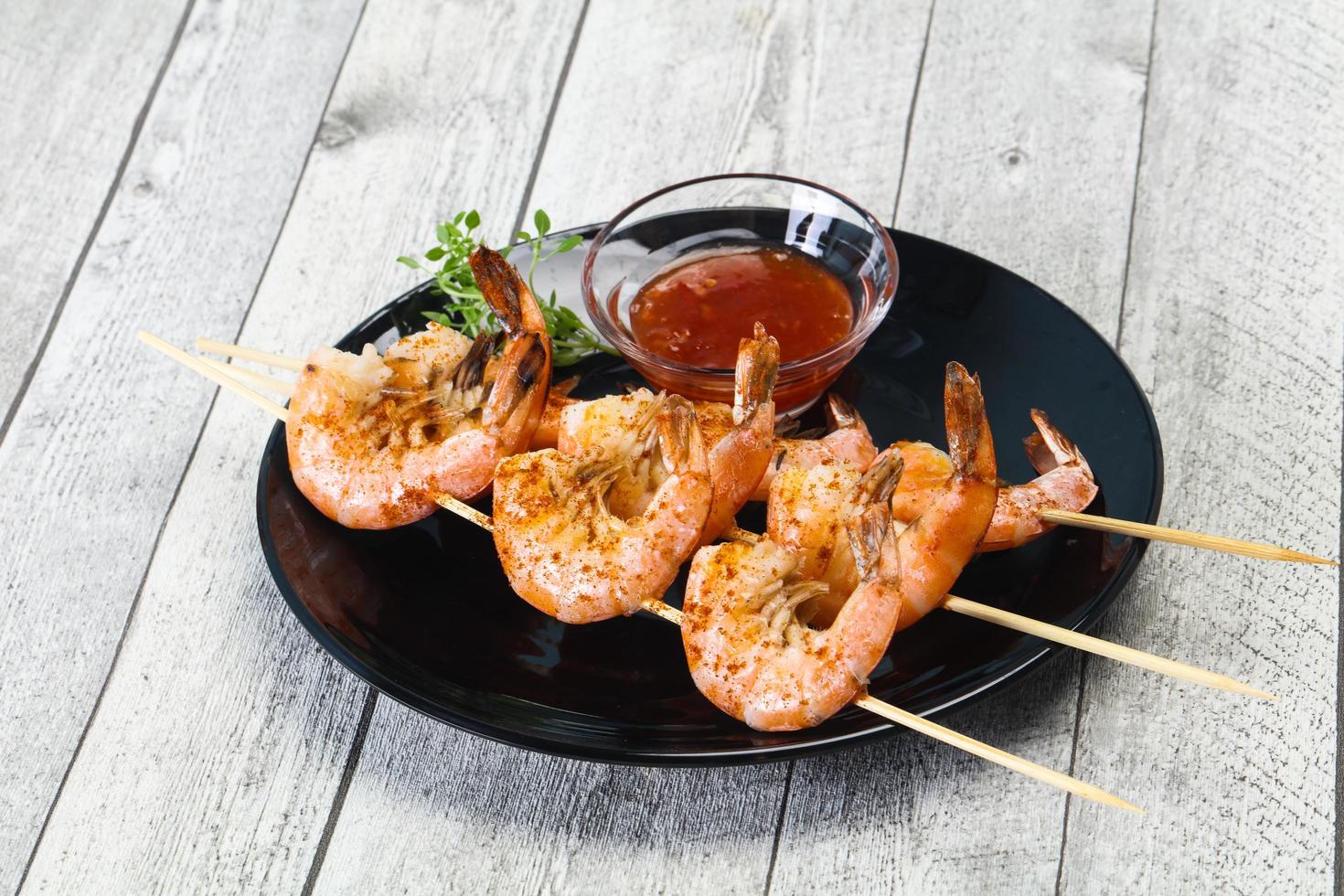 Grilled prawn skewer with sauce photo