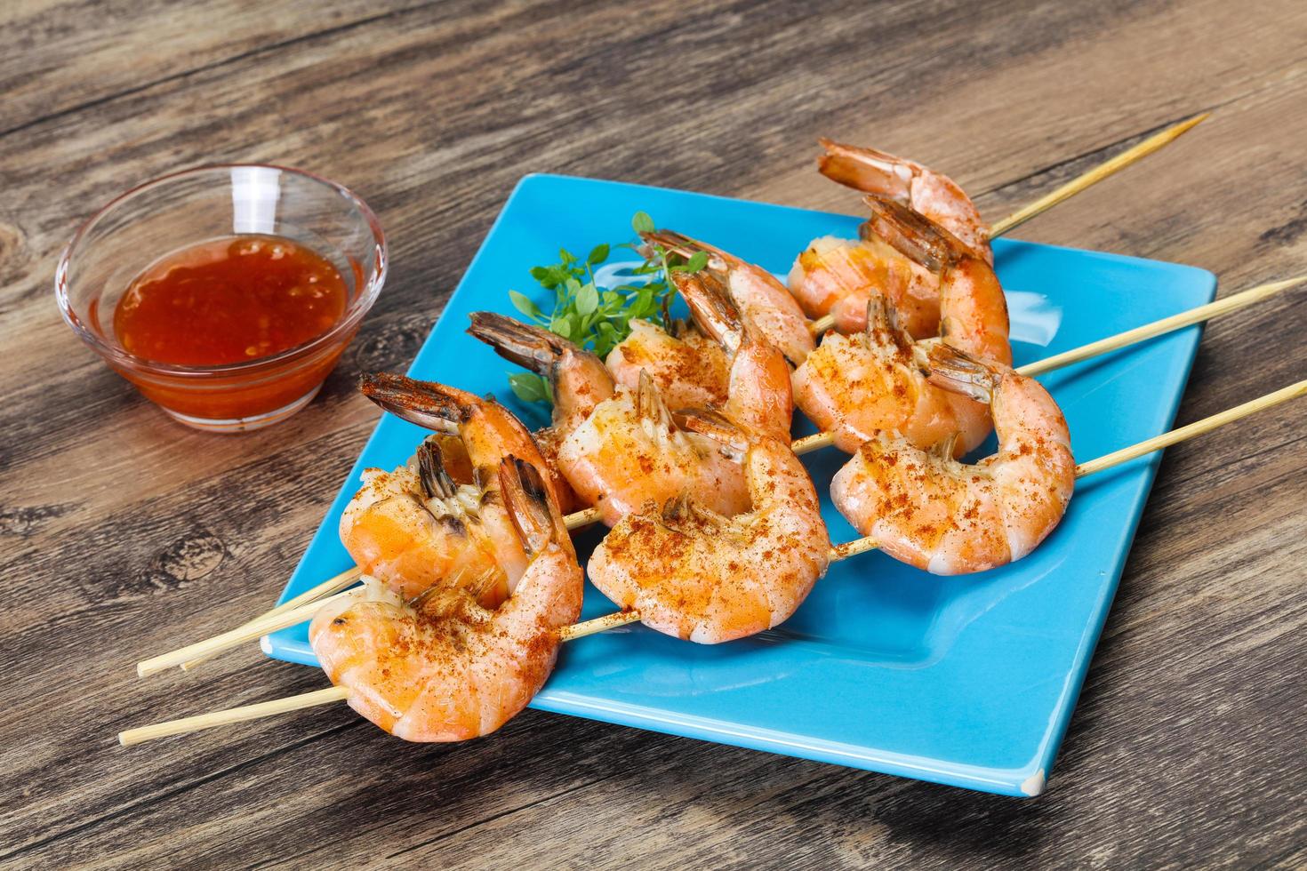 Grilled prawn skewer with sauce photo