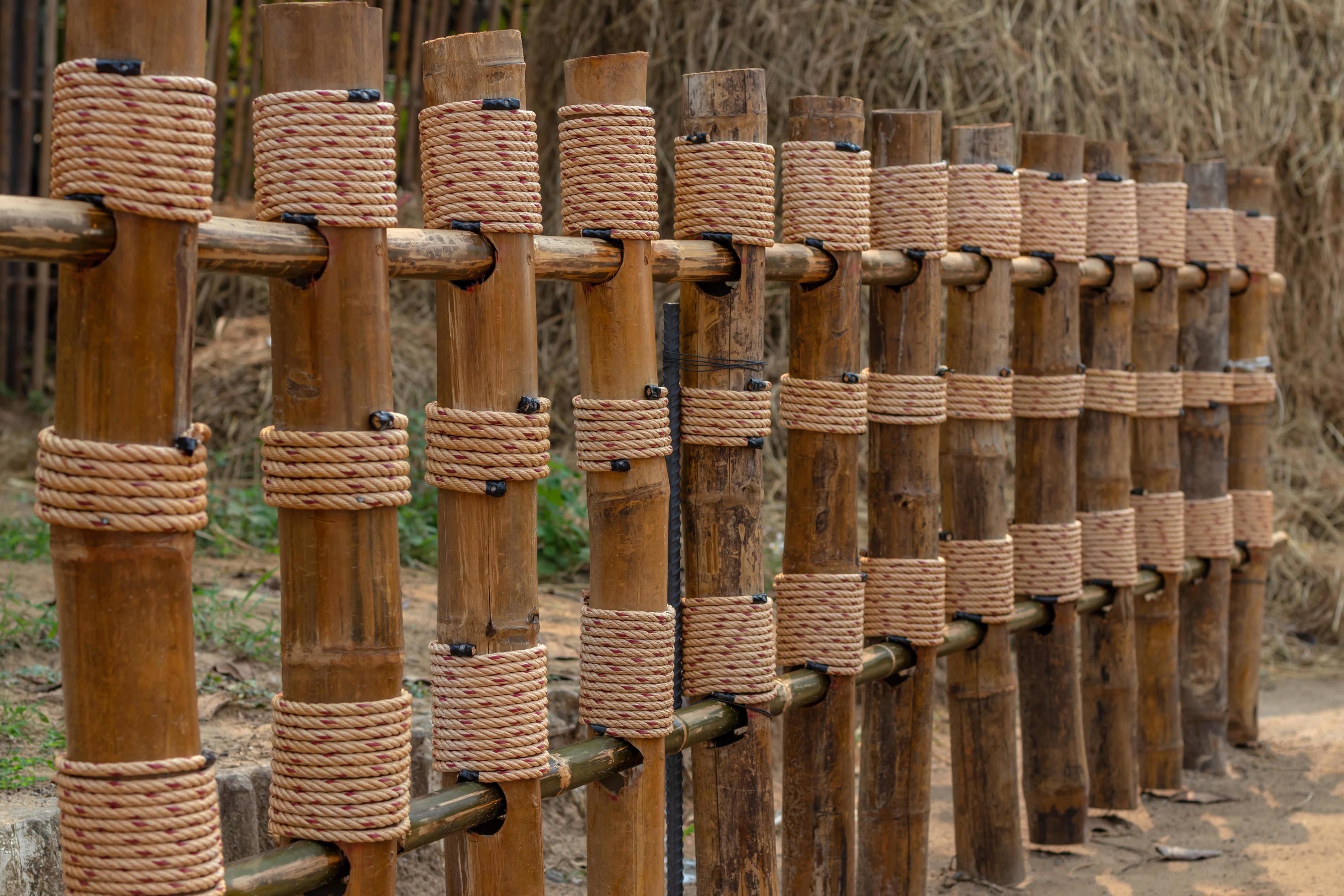 Fence of bamboo poles wrapped with rope. 7664731 Stock Photo at Vecteezy