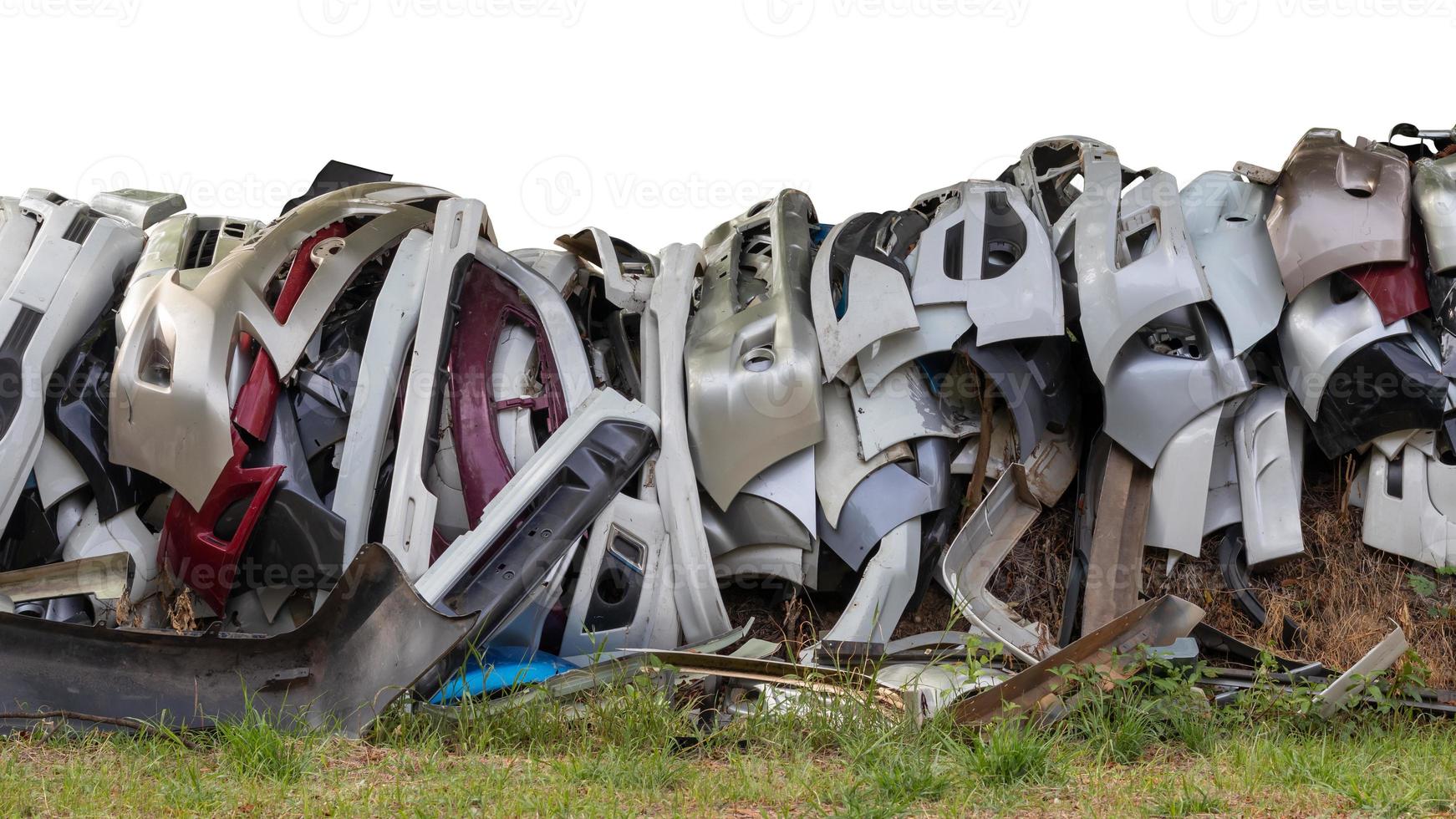 Isolates, many front bumper parts, stacked up together. photo