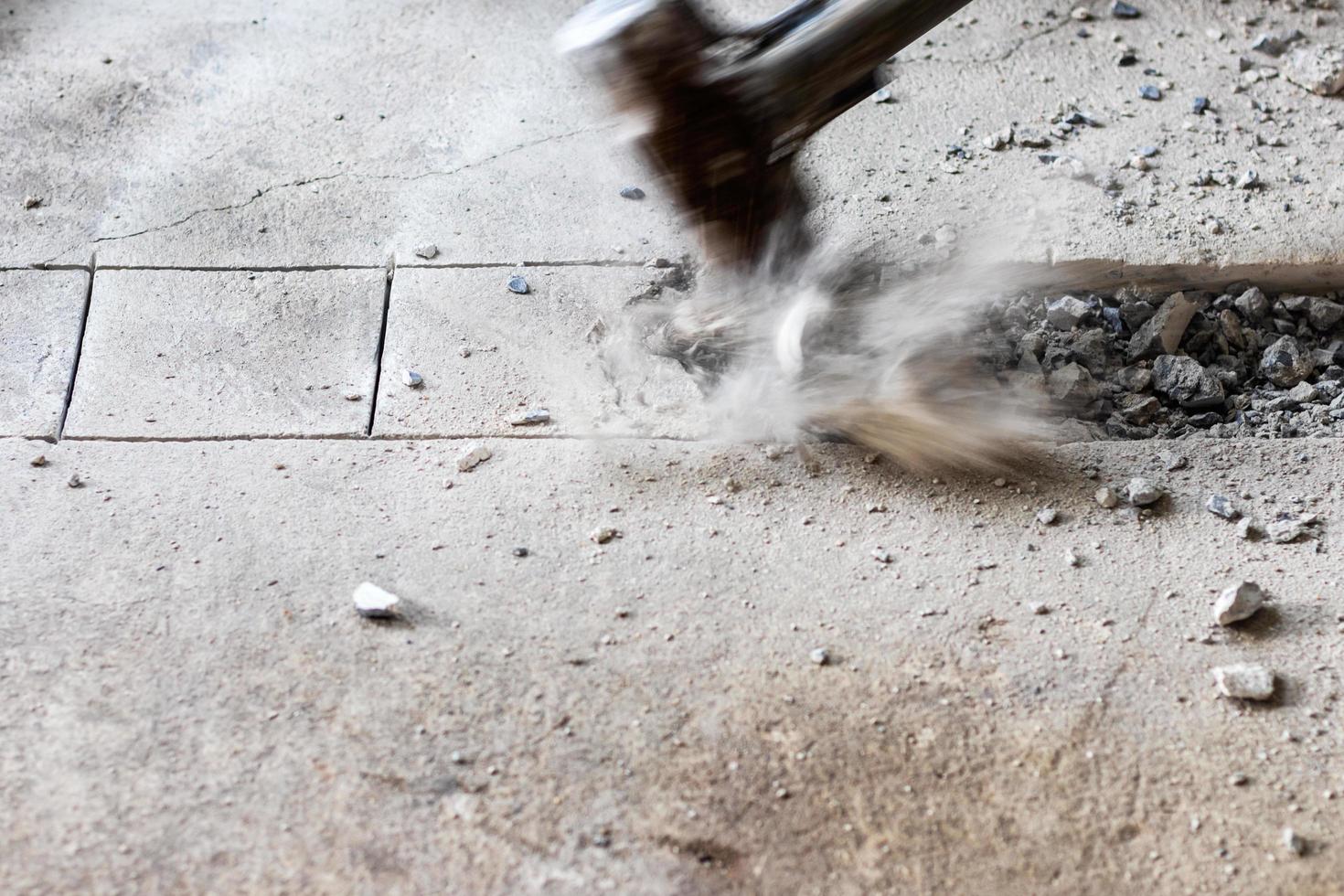 A large hammer bashed into the concrete. photo