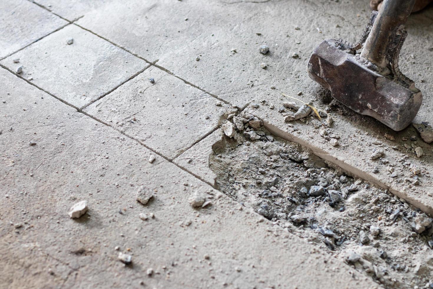 A large hammer bashed into the concrete. photo