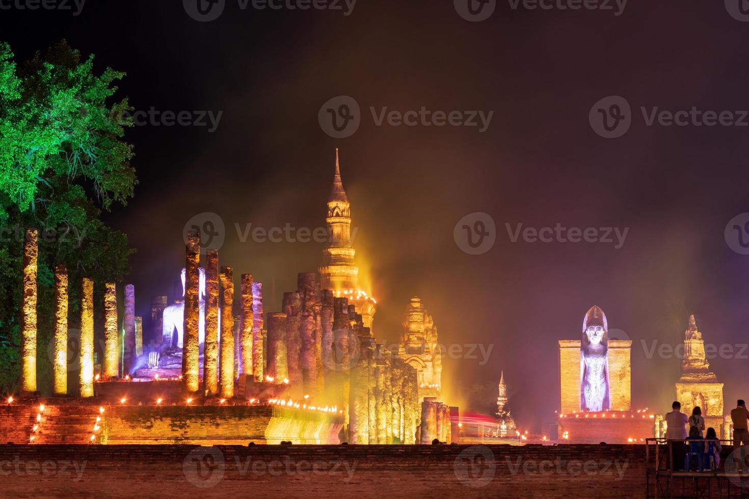 Old Buddhist temple at night with lights and smoke. photo