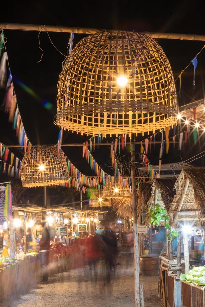 Lighting from chicken coop hung over the night market. photo