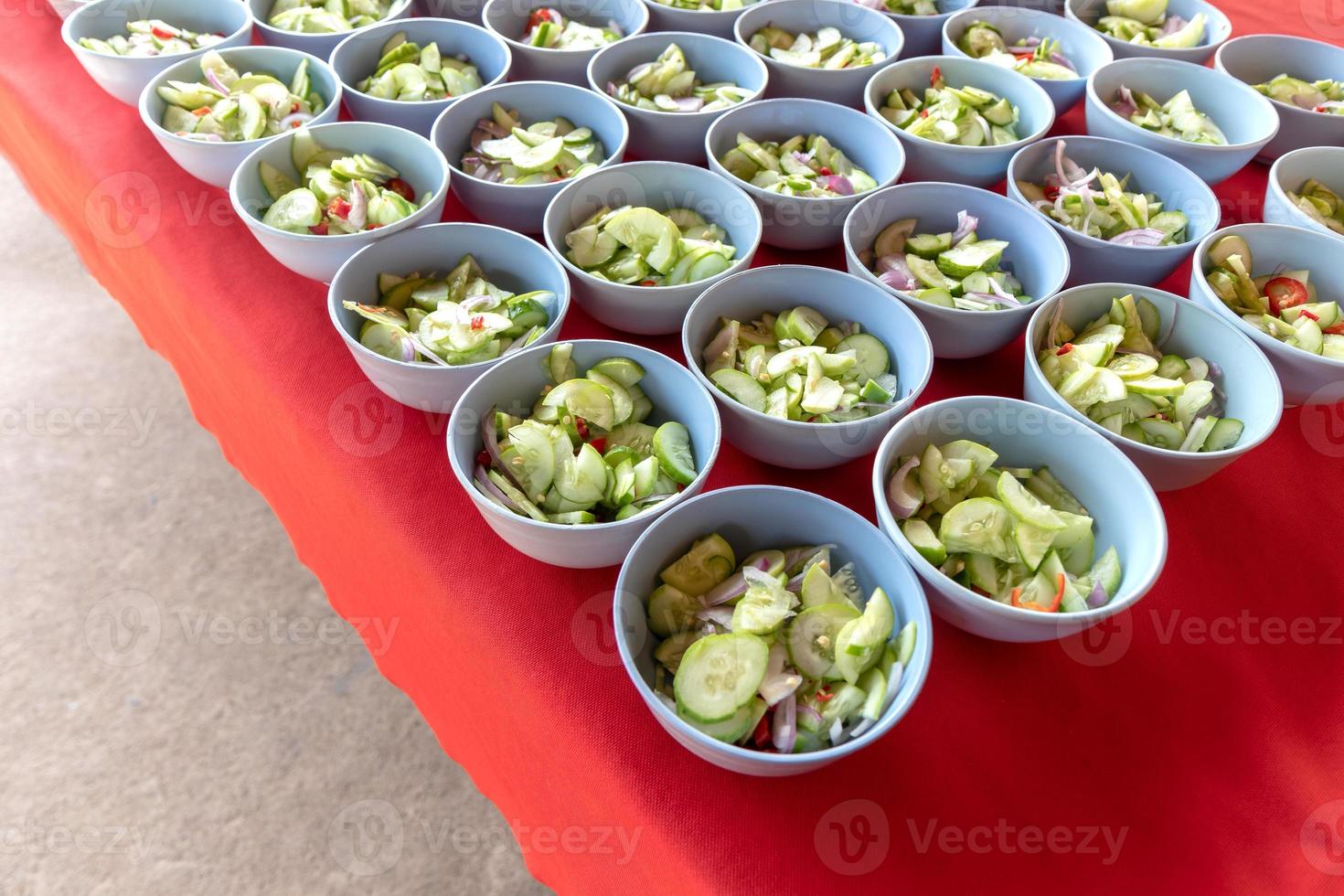 Chopped cucumber slices in a cup of red cloth. photo