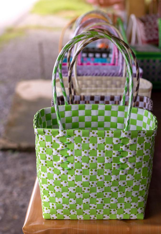 Basket of wicker green ribbons arranged on the table. photo