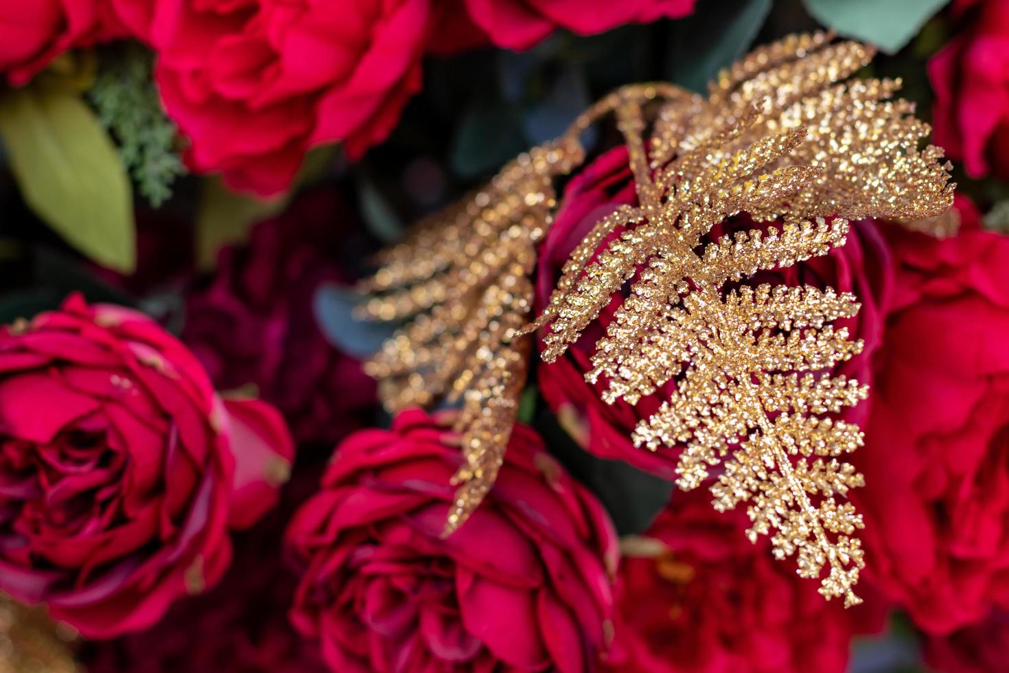 Golden pine leaves with red flowers. photo