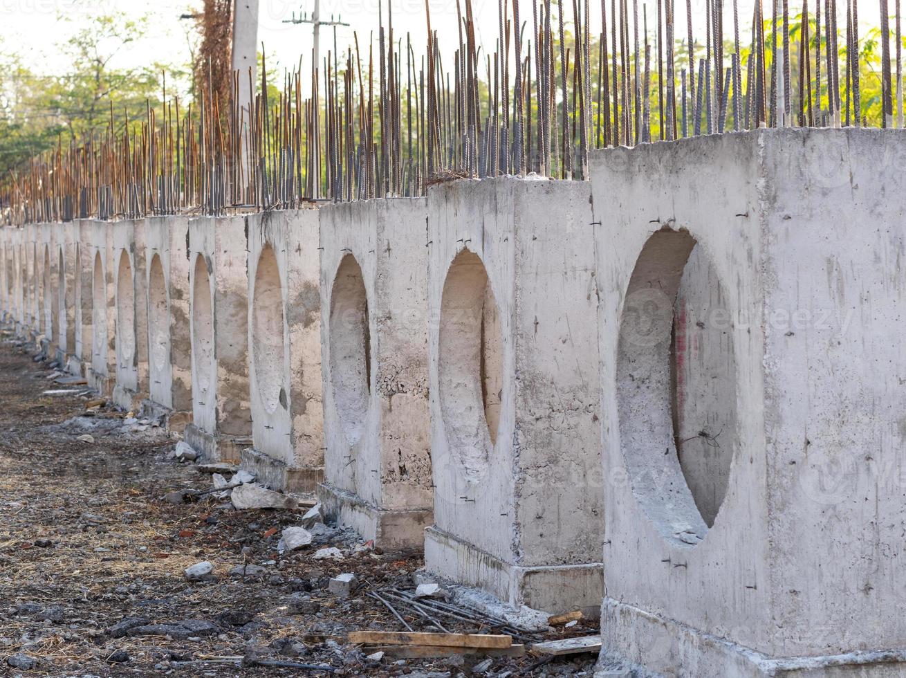 A row of rectangular concrete blocks to place a plumbing pipe. photo