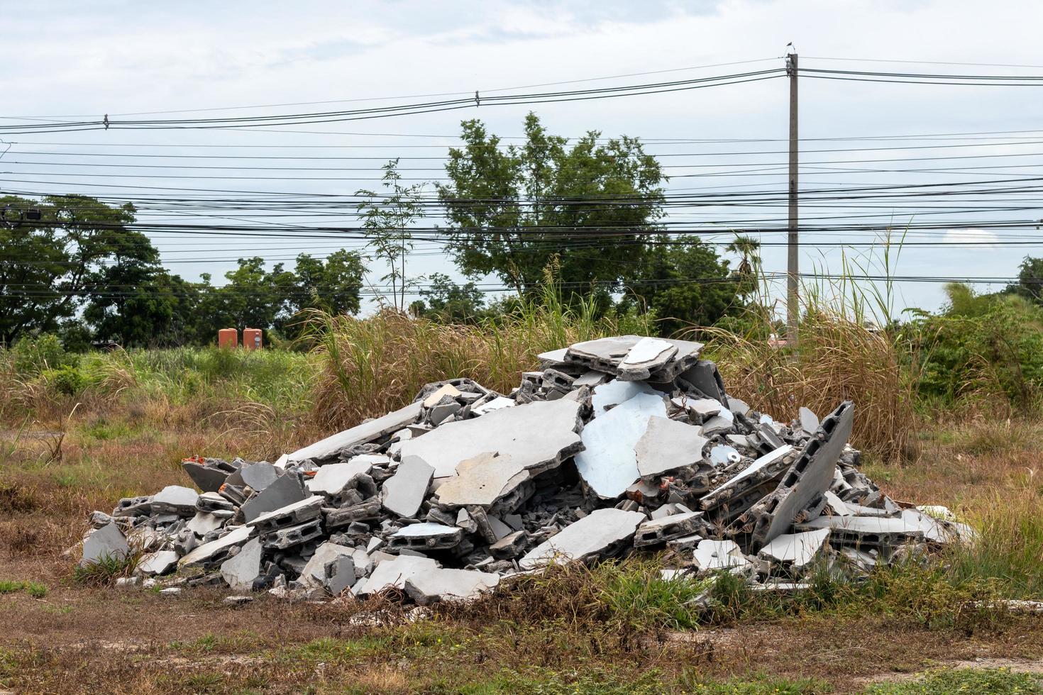 Debris debris, brick wall near concrete fence. photo