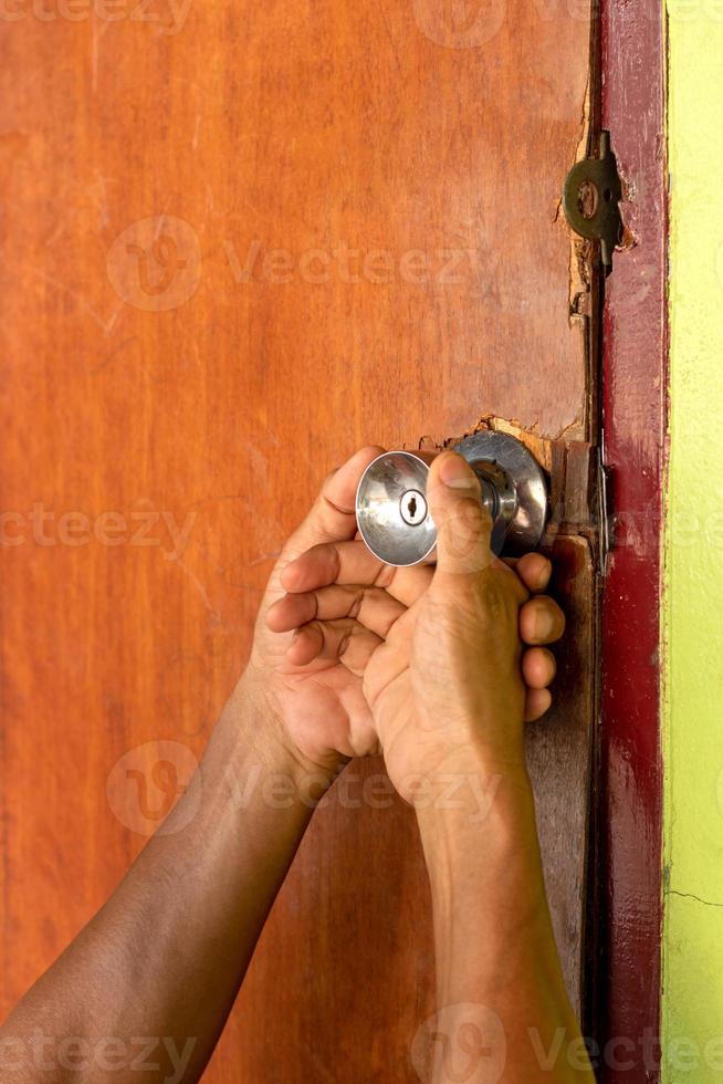 Both hands are worn and the old wooden door knob is damaged. photo