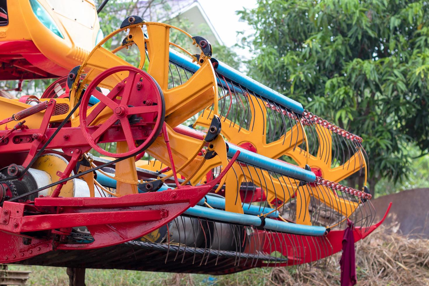 The front of the combine harvesters is yellow and red. photo