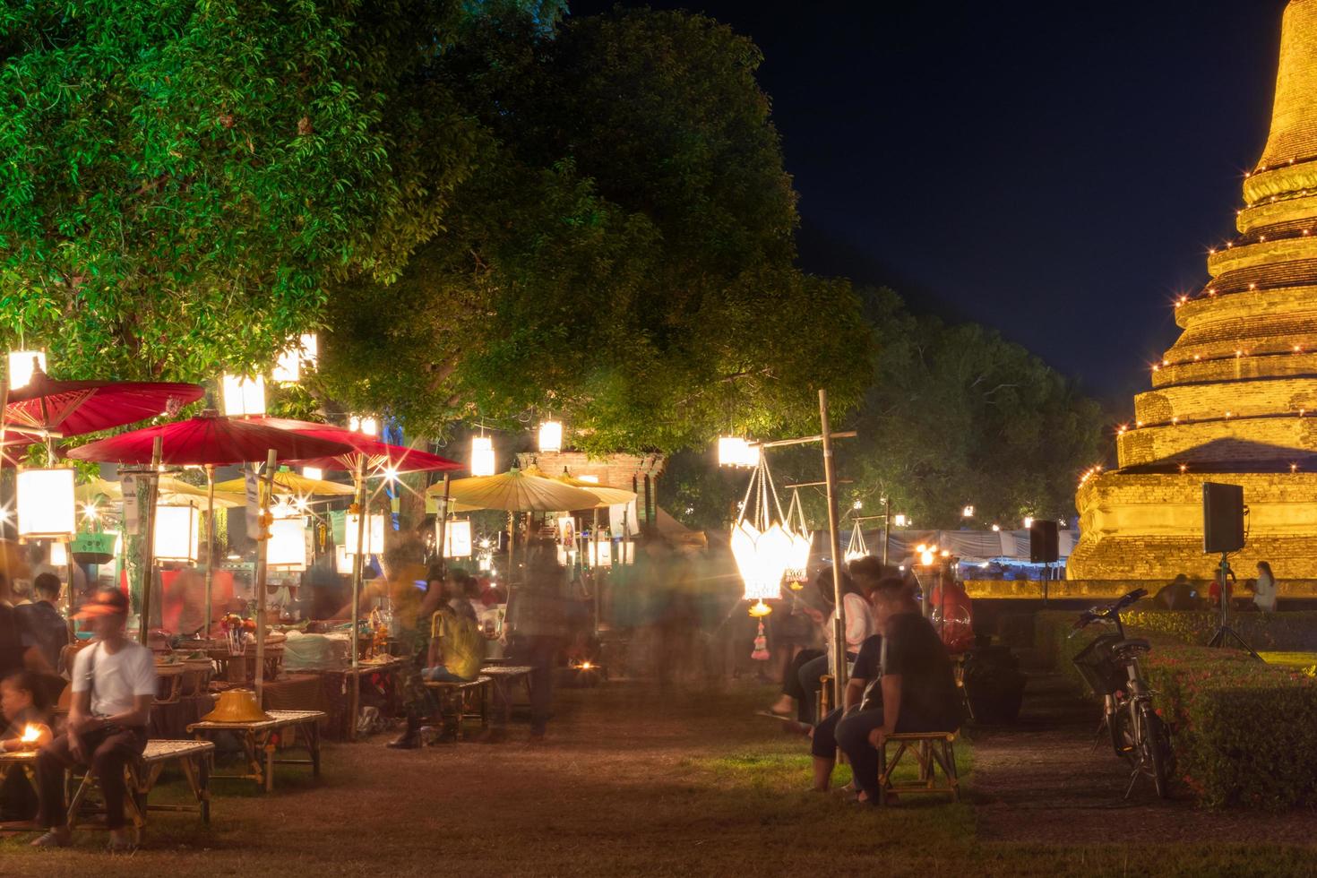 People blur sitting in the ancient market at night. photo