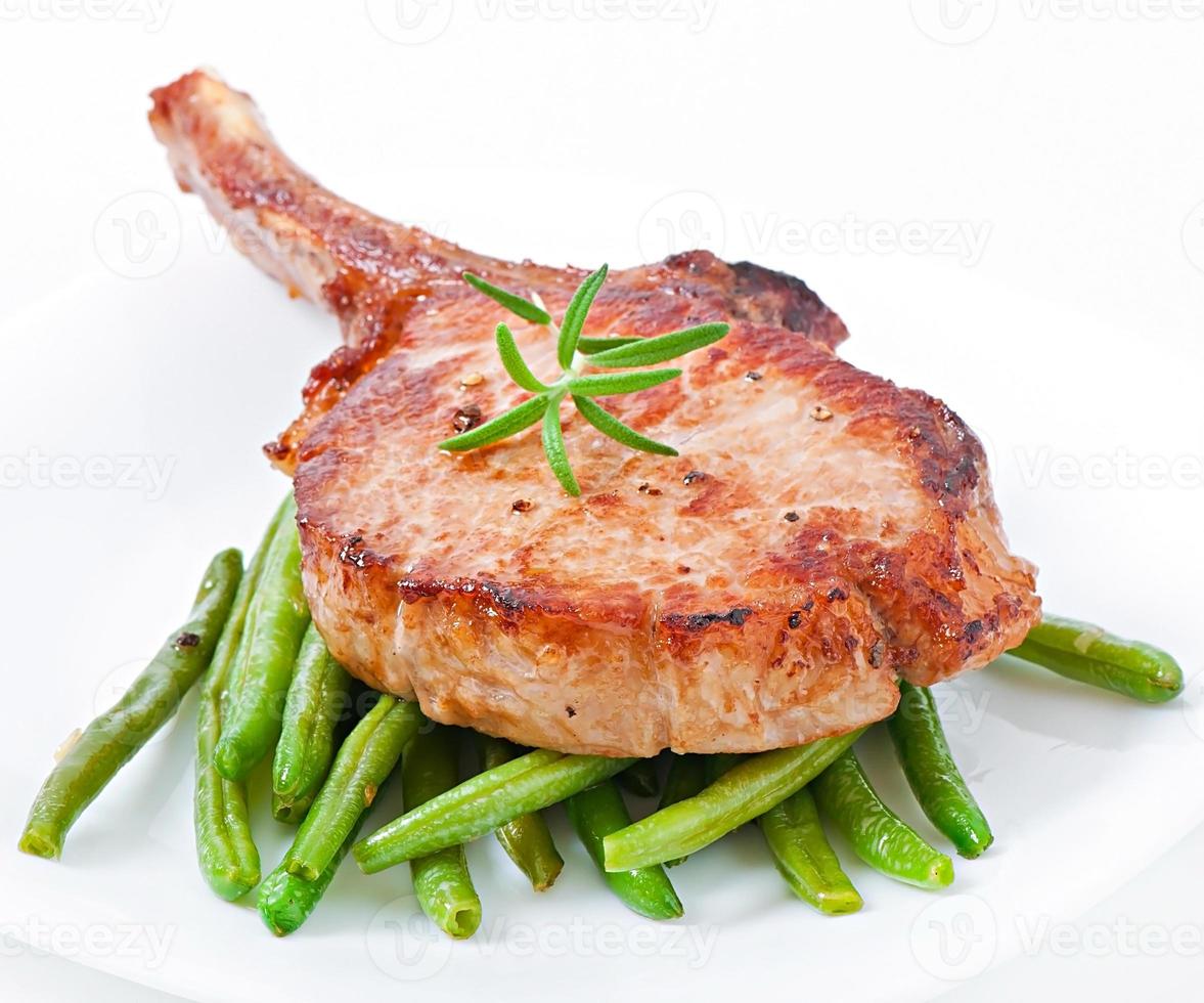 Juicy grilled pork fillet steak with  green beans photo