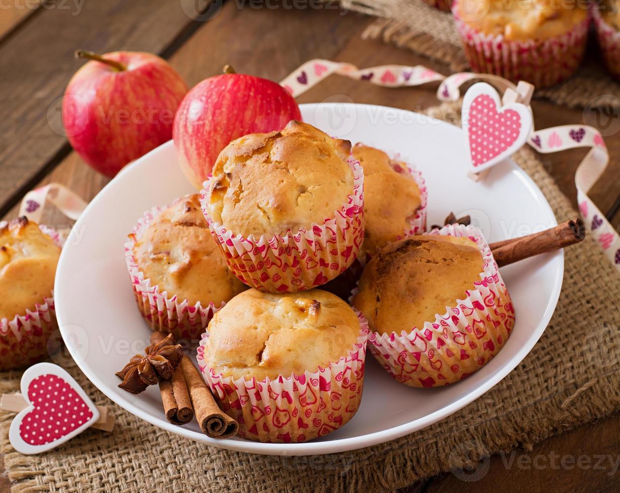 Fruit muffins with nutmeg and allspice in a wicker basket on a wooden background photo