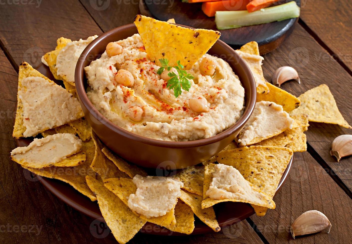 Healthy homemade  hummus with olive oil and pita chips photo