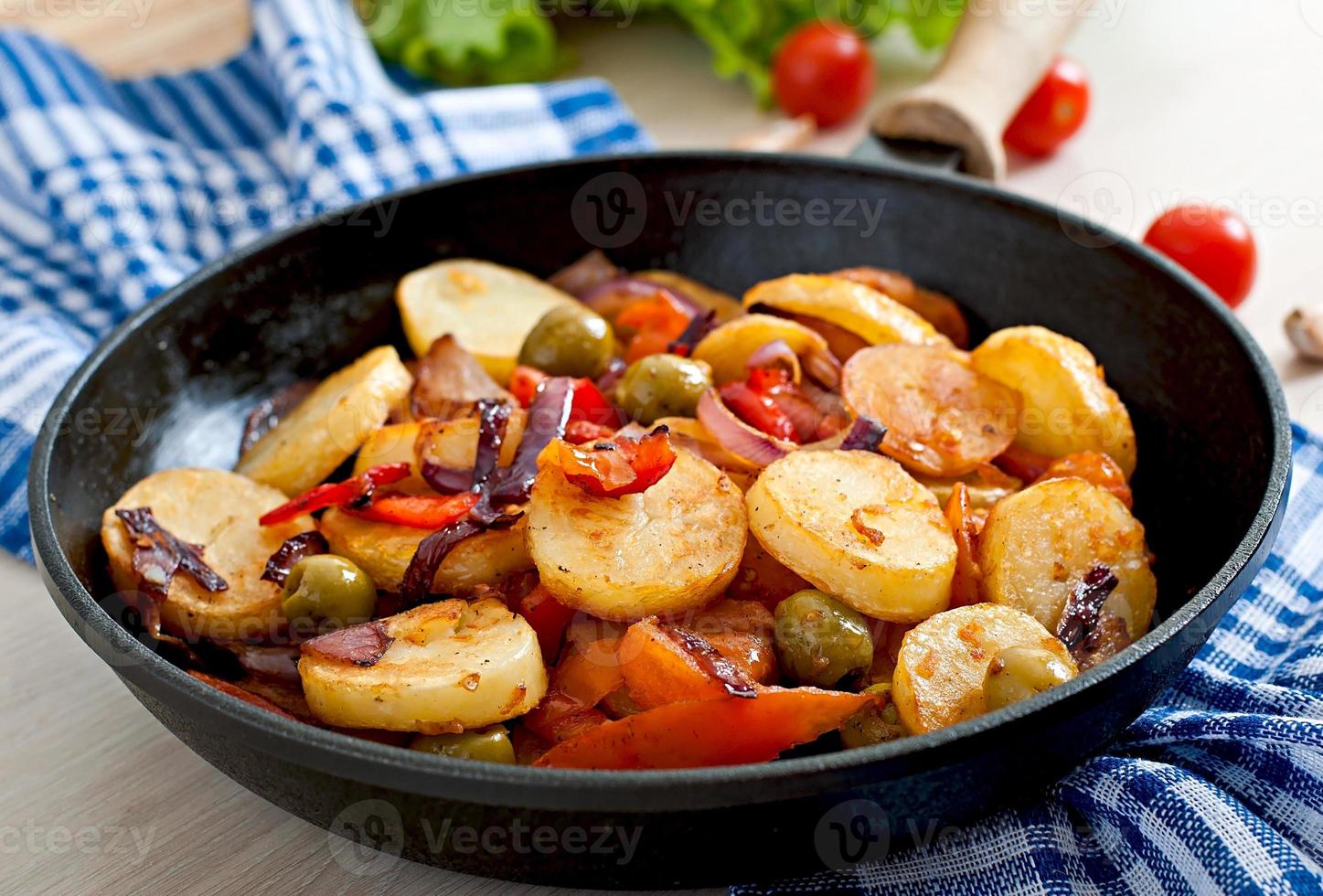 Baked potato with vegetables in a frying pan photo