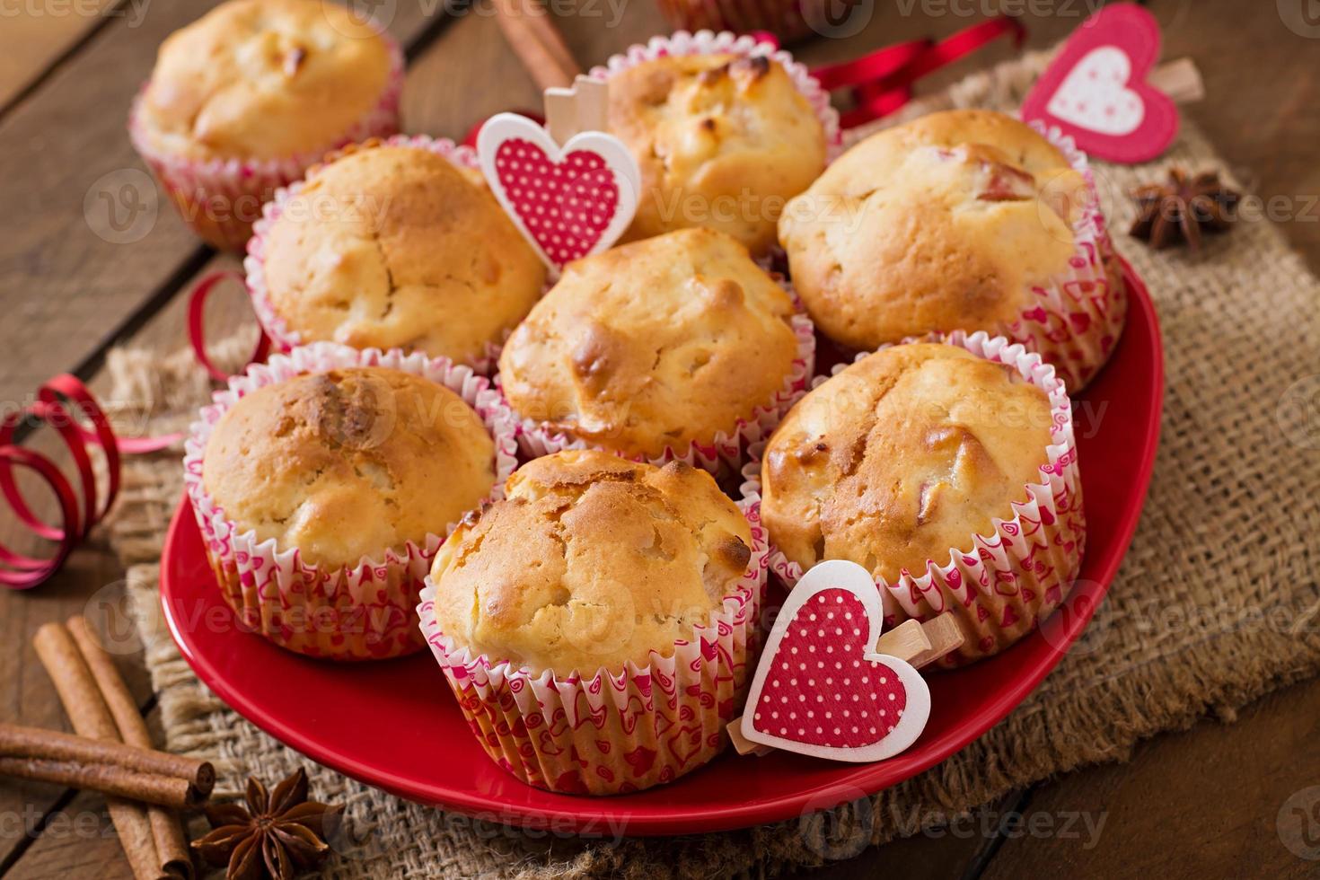 Fruit muffins with nutmeg and allspice in a wicker basket on a wooden background photo