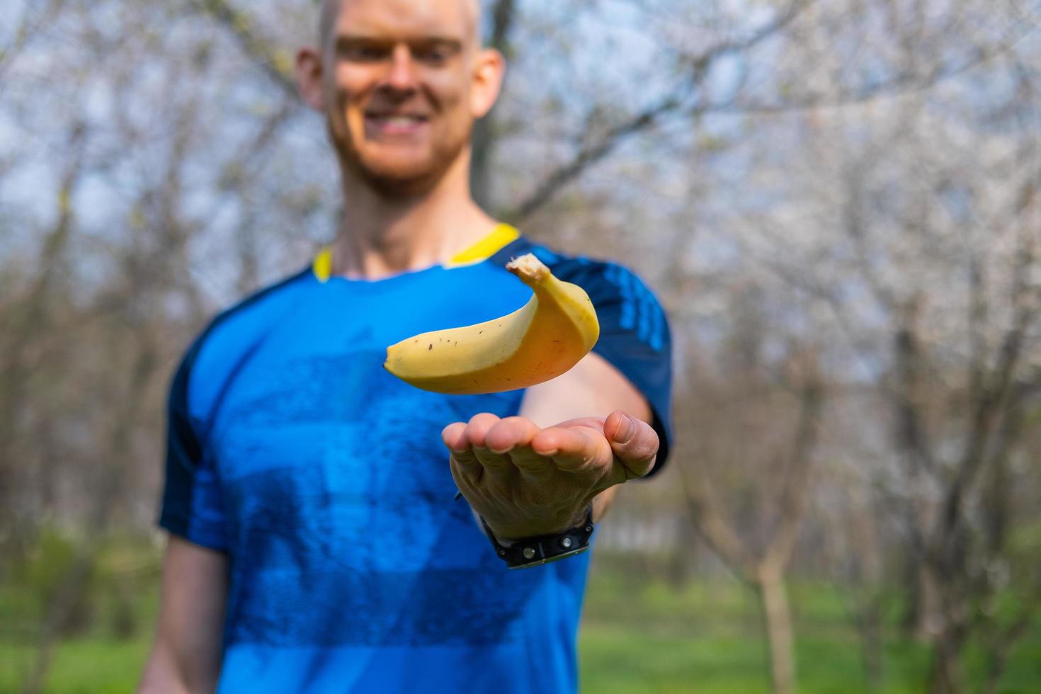Fiy happy male with banana in hands photo
