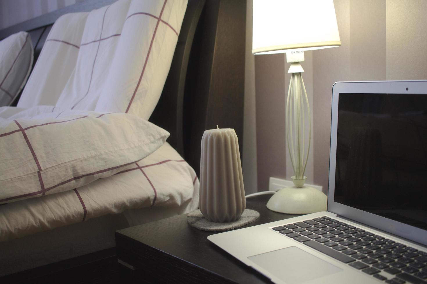 Part of interior living room, laptop stand on grey sofa with pillows photo