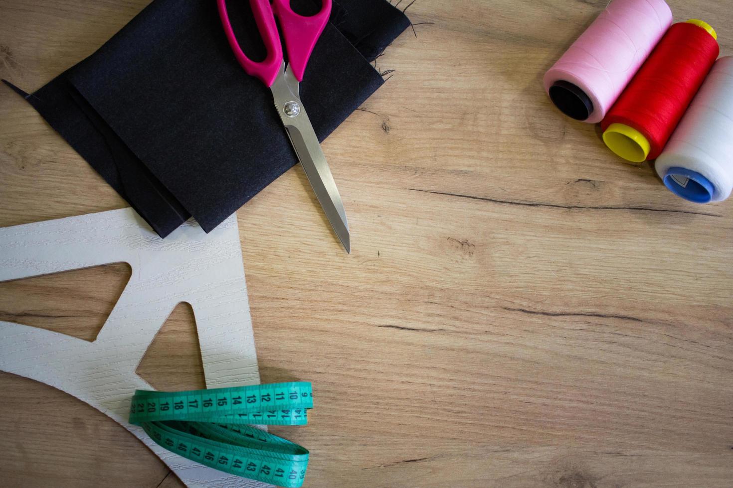 Sewing accessories, tools and cloth on seamstress table photo