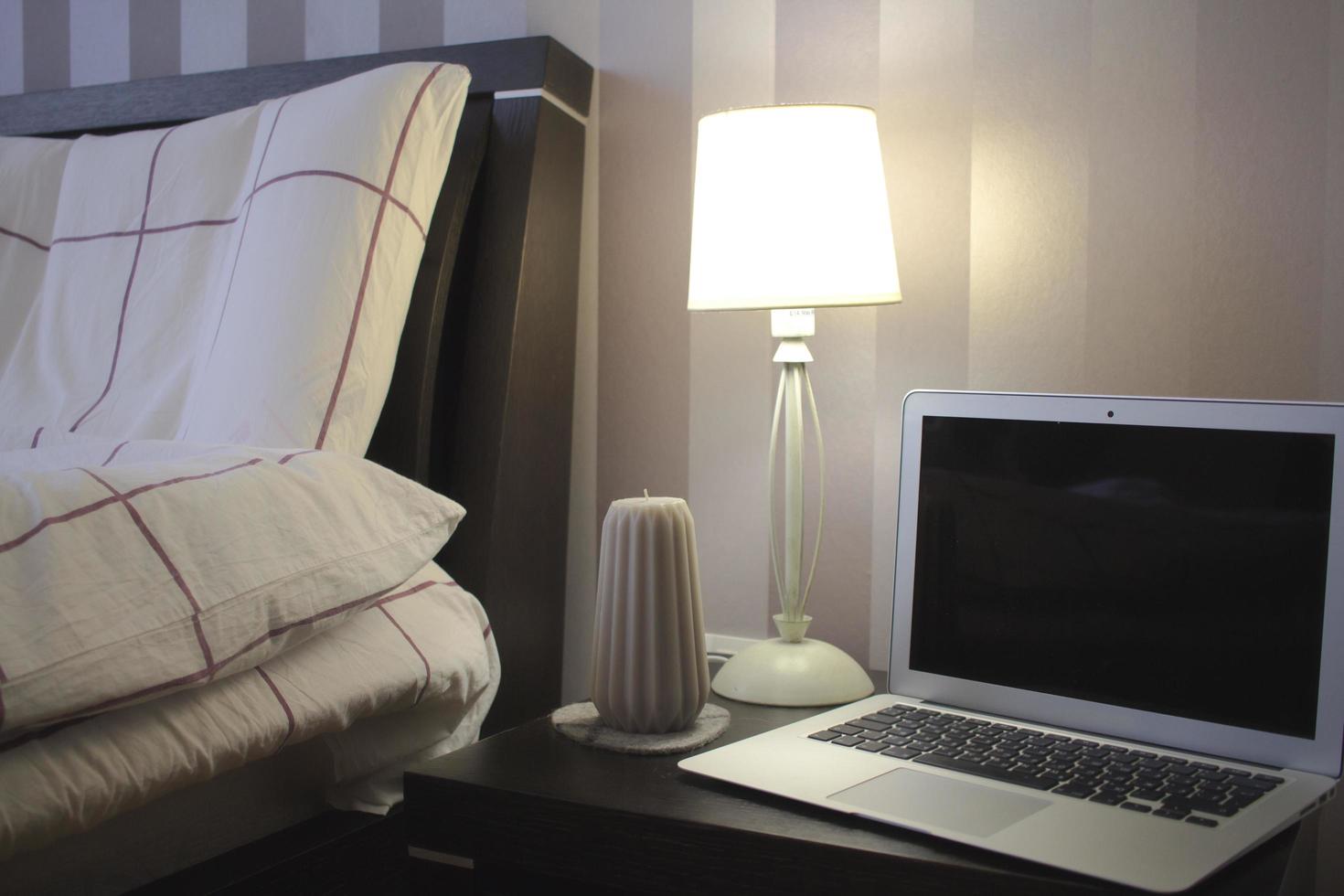 Part of interior living room, laptop stand on grey sofa with pillows photo