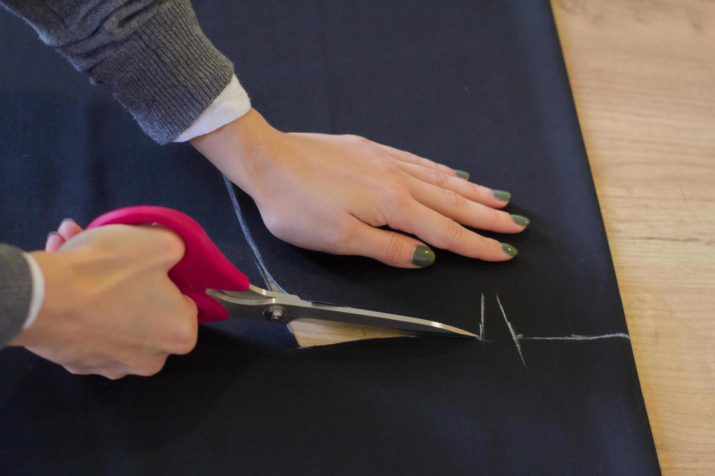 Sewing accessories, tools and cloth on seamstress table photo