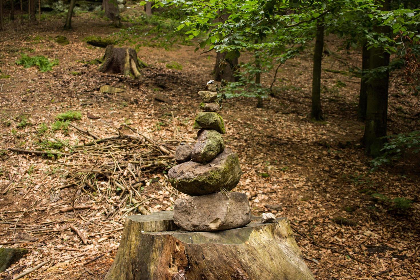 Stone tower in forest on the hiking road photo