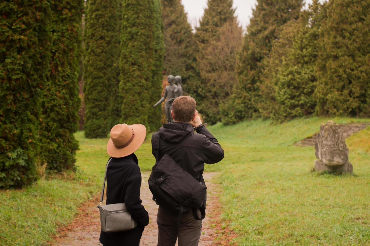 couple of tourist walking having good time in autumn park photo