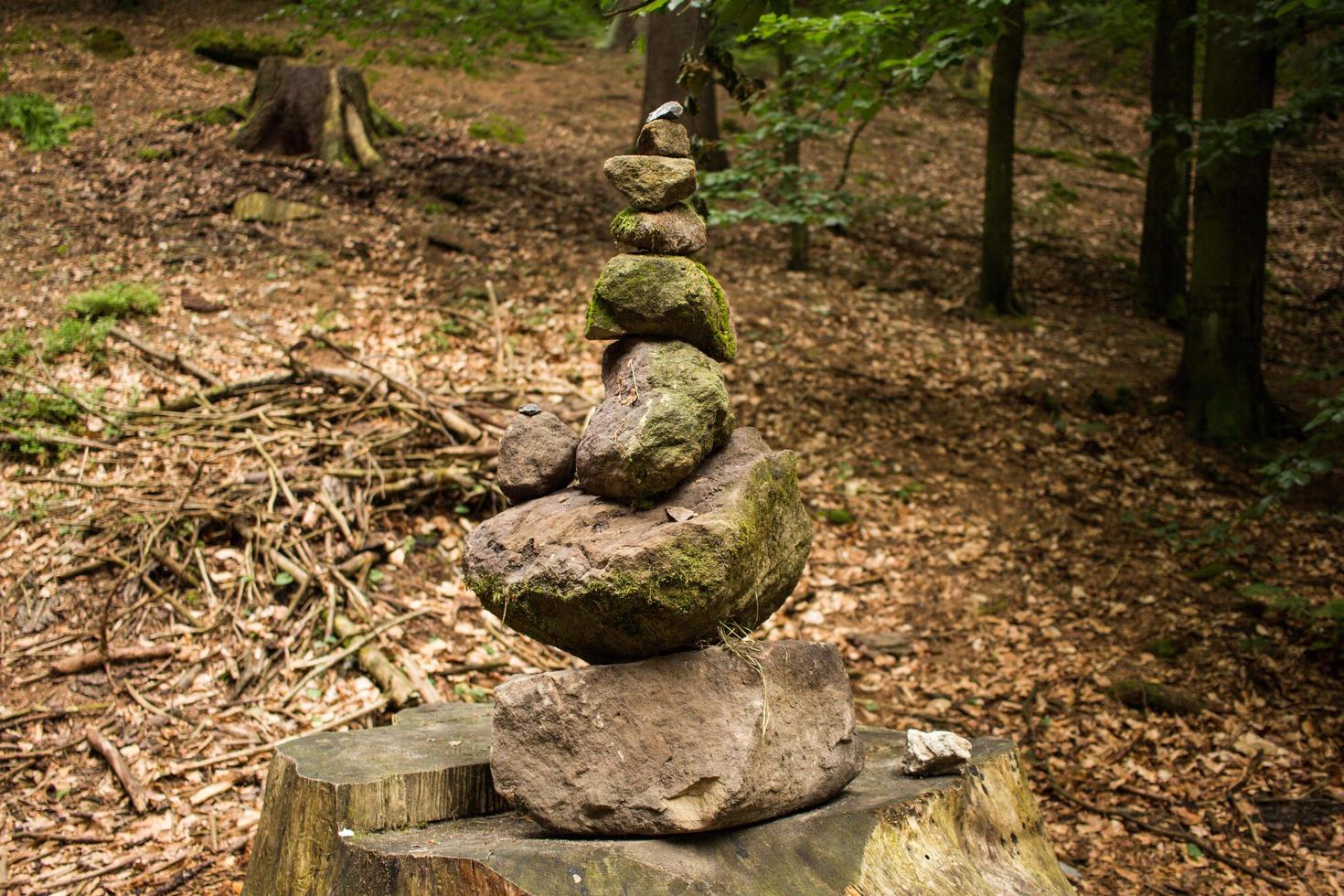 Stone tower in forest on the hiking road photo