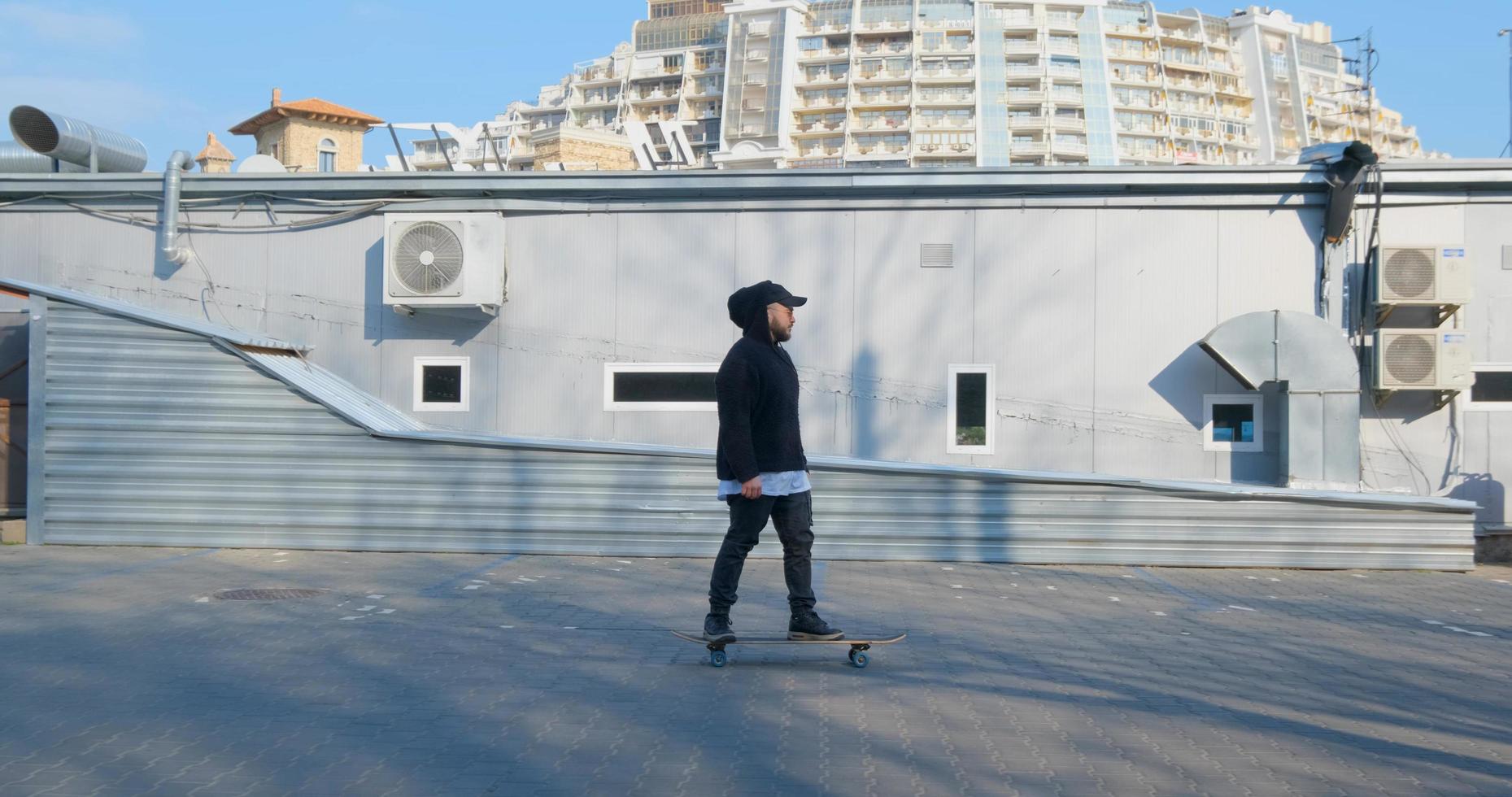 Young male ride on longboard skate on the streets photo