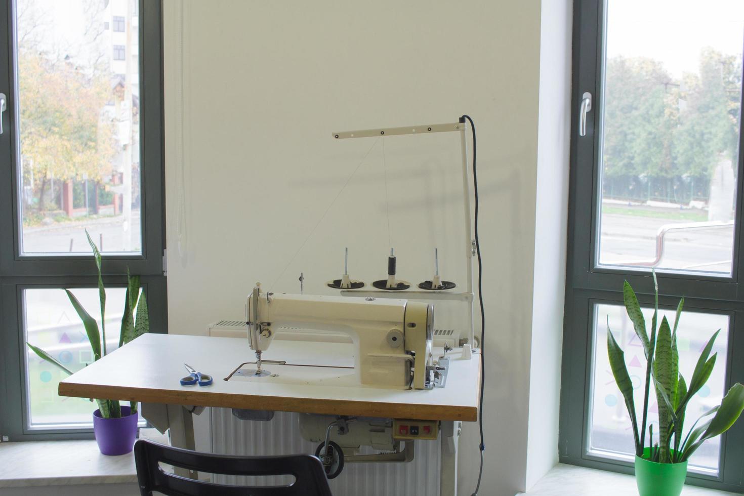 sewing machine on work table in tailor studio photo