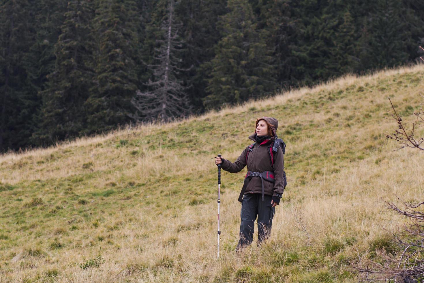 young woman hiker in autumn forest photo