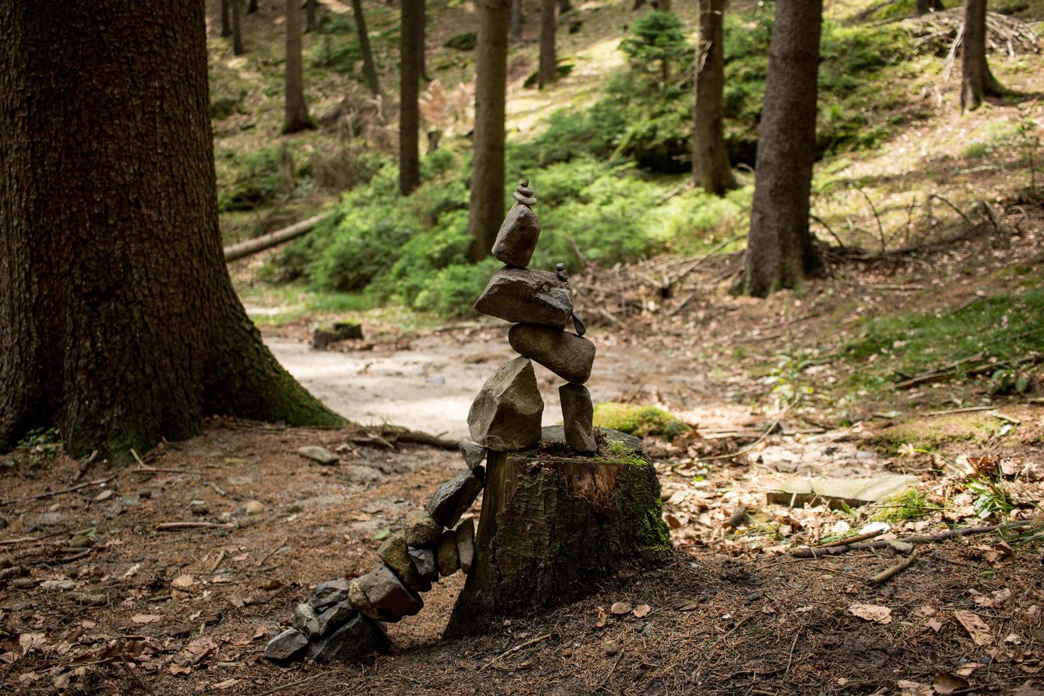 Stone tower in forest on the hiking road photo