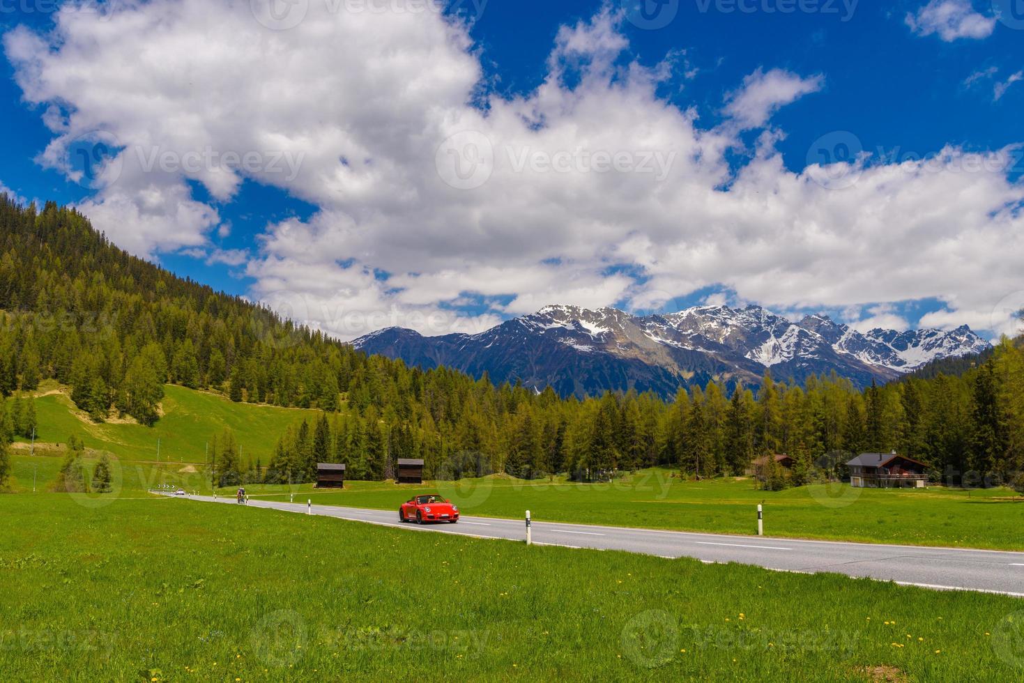 Red Porsche 911 997 in Alps mountains, Davos,  Graubuenden, Swit photo