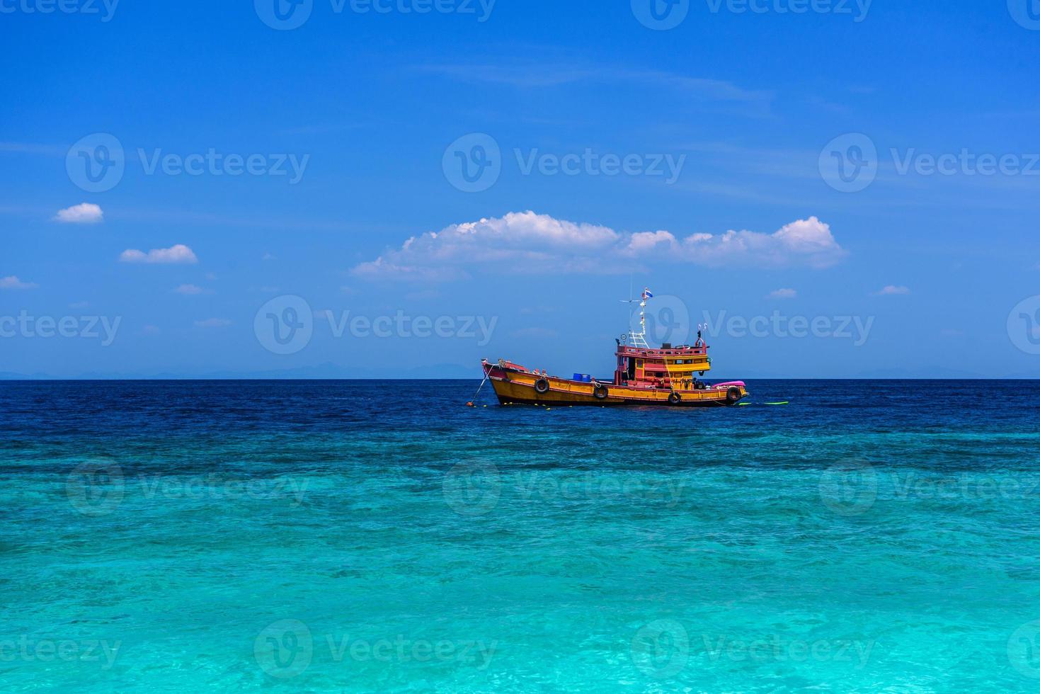Orange ferry ship in azure sea, Loh Moo Dee Beach, Phi Phi Don, photo