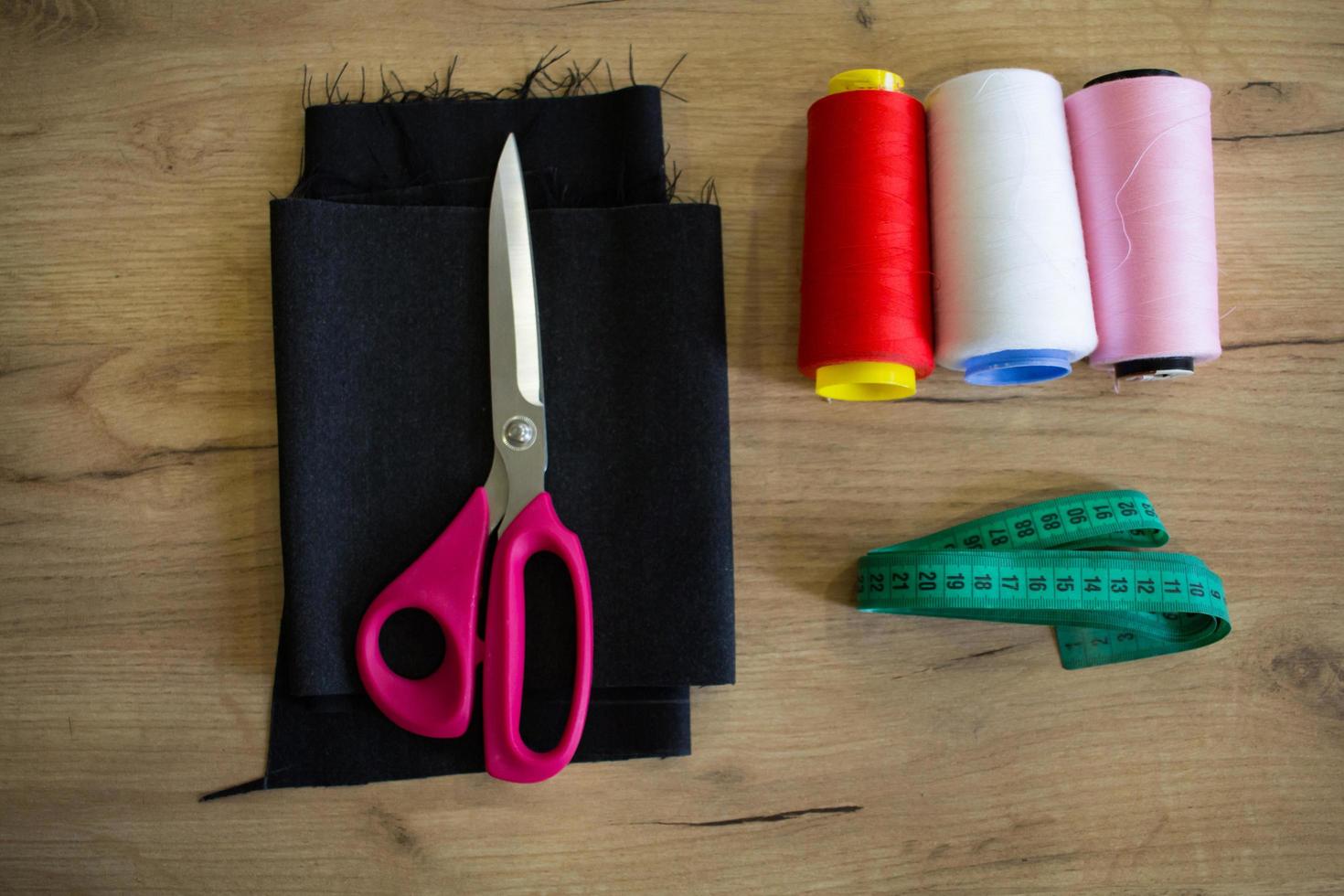 Sewing accessories, tools and cloth on seamstress table photo