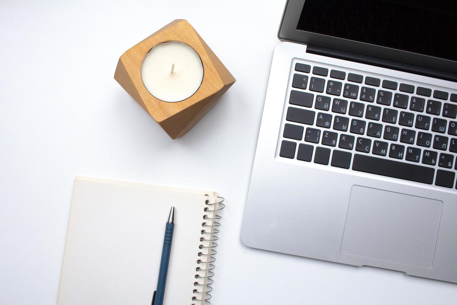 notebook on white table with gadgets and decorations, top view of writer, freelancer or buisinessman work place photo