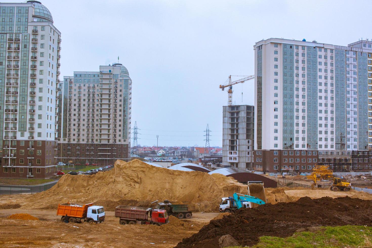 Concrete building in progress with cranes photo